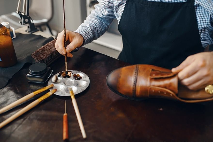 Artisan finishing a handcrafted leather shoe